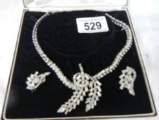 A cased diamonte necklace with matching earrings.