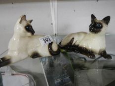 Two Royal Doulton Siamese cats.