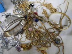 A tray of white and yellow metal jewellery.
