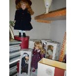 Five boxed collector's porcelain dolls.