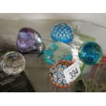 Two millifiori glass paperweights and four others.