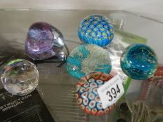 Two millifiori glass paperweights and four others.