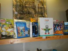 A quantity of mostly new sealed toys including Star Wars, Jigsaw, Pocket microscope, etc.,