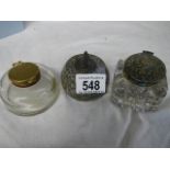 Two glass inkwells and an inkwell in the form of a curling stone.