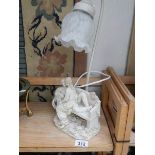A table lamp with lover's on bench base.