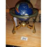 A jewelled globe on stand.