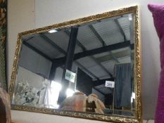 A large gilt framed bevel edged mirror, 82 x 52 cm. COLLECT ONLY.