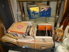 A box of 45 rpm records and a box of CD's.