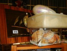 A shell ship picture and a quantity of sea shells.