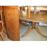 An oval extending dining table. COLLECT ONLY.