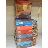 Eight jigsaw puzzles, complete in bags.