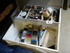 A needlework box with contents.