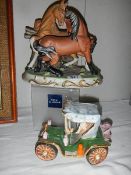A pair of ceramic fighting horses and a ceramic car.