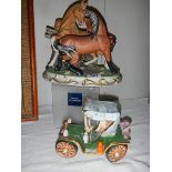 A pair of ceramic fighting horses and a ceramic car.