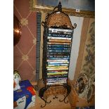 A cane and metal DVD rack with DVD's, COLLECT ONLY.