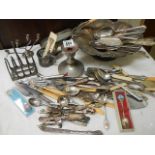 A mixed lot of flat ware, toast rack, candlesticks etc.,