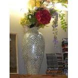 A tall silver coloured vase with faux flowers. COLLECT ONLY.