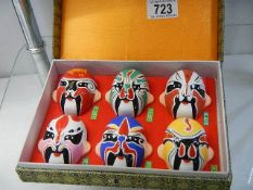 A boxed set of six painted masks