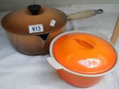 A cast iron pan and a ceramic casserole dish.