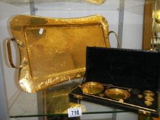 A brass tray and a set of brass precious metal scales.