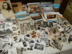 A large mixed lot of postcards and black & white photographs.