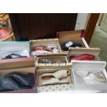 Eight pairs of previously worn shoes in boxes.