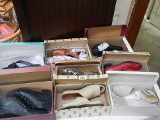 Eight pairs of previously worn shoes in boxes.