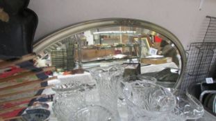 An oval framed mirror. COLLECT ONLY.