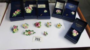 A quantity of porcelain flower brooches.