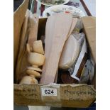 A box of assorted new wooden items.