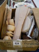 A box of assorted new wooden items.