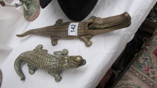 Two brass crocodiles.