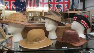 A Hunter Glenwood hat size 53, a Glengarry, two straw hats and one other.