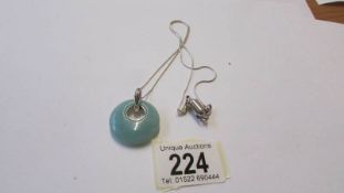 A silver and jade pendant.