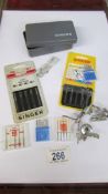 A quantity of sewing machine needles etc.,