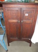 A two door oak cupboard. COLLECT ONLY.