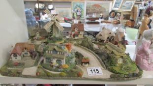 A quantity of cottages on base, including Royal Doulton. COLLECT ONLY.