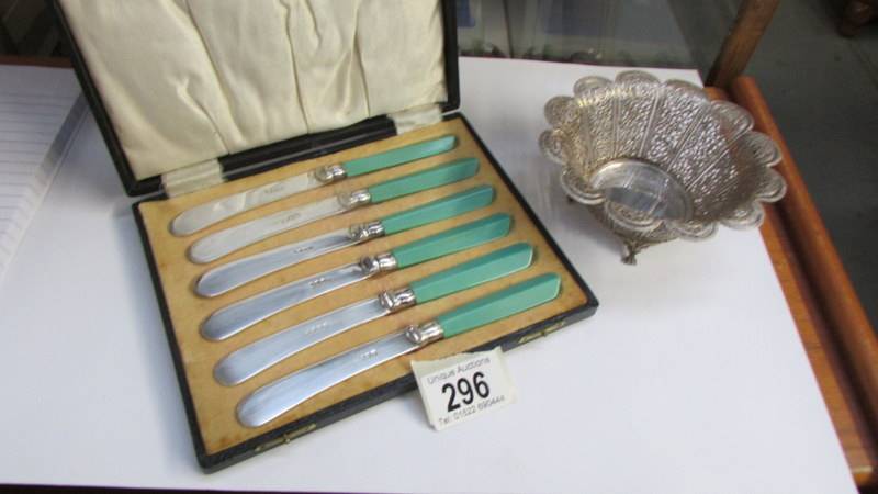 A cased set of butter knives and a filigree sweetmeat dish.