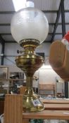 A brass oil lamp with shade. COLLECT ONLY.