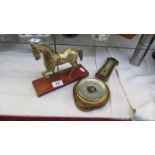 A brass carousel horse and a barometer.