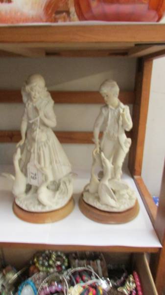 A pair of bisque figurines.