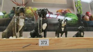 Four pit bull terrier figures.