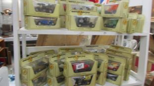 Two shelves of 35 Matchbox Models of Yesteryear die cast models.