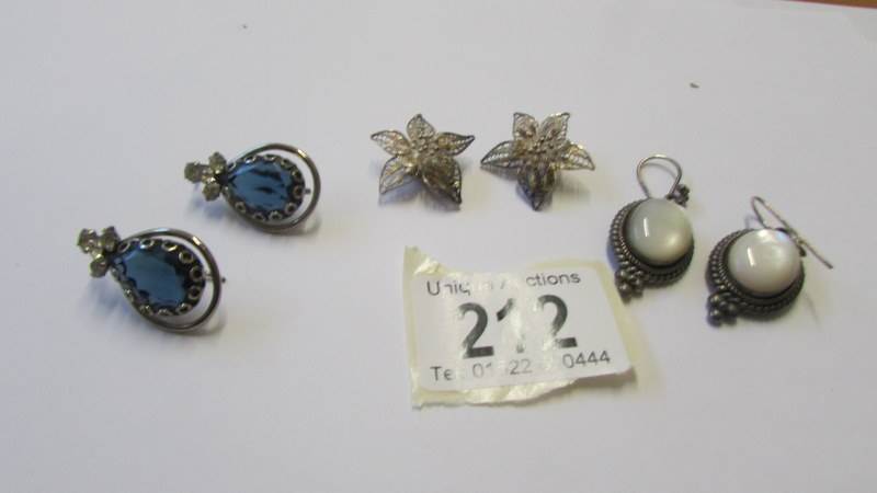 Three good pairs of silver earrings.