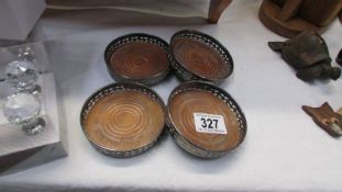 A set of four silver plate wine coasters.