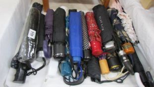 A quantity of folding umbrella's.