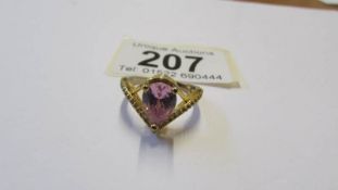 A silver ring with pale pink heart shaped stone, size P.