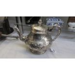 An ornate silver plate teapot, lid needs fixing otherwise in good condition.