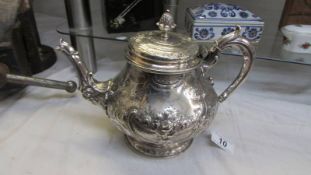 An ornate silver plate teapot, lid needs fixing otherwise in good condition.