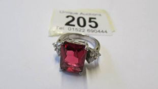 A silver ring set large pale ruby coloured stone, size O.